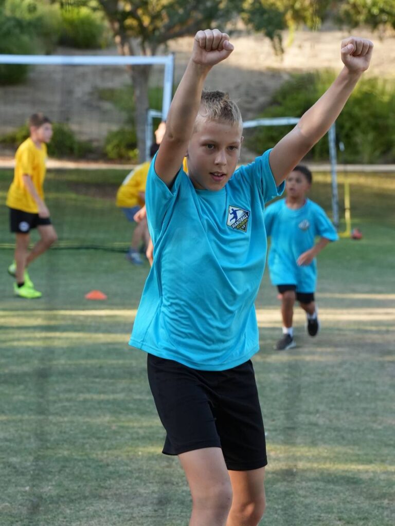 A young player celebrating a goal at the handball tournament