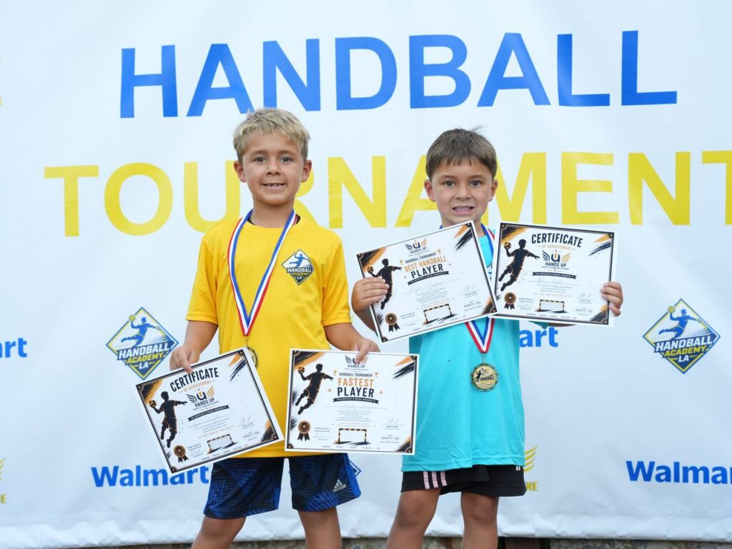 Two young athletes with their certificates of achievement and medals