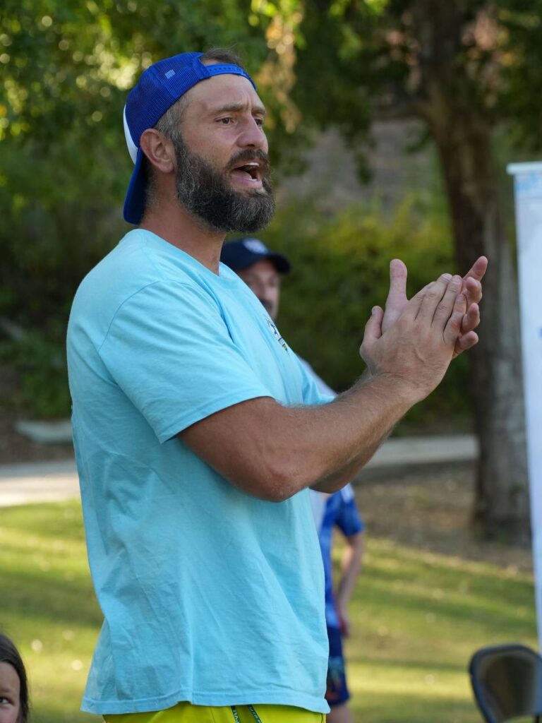 Volunteer coach Dmytro Doroshchuk encouraging the young athletes