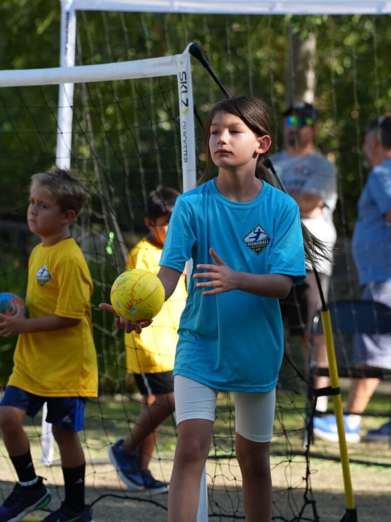 A young player preparing to throw during the handball tournament