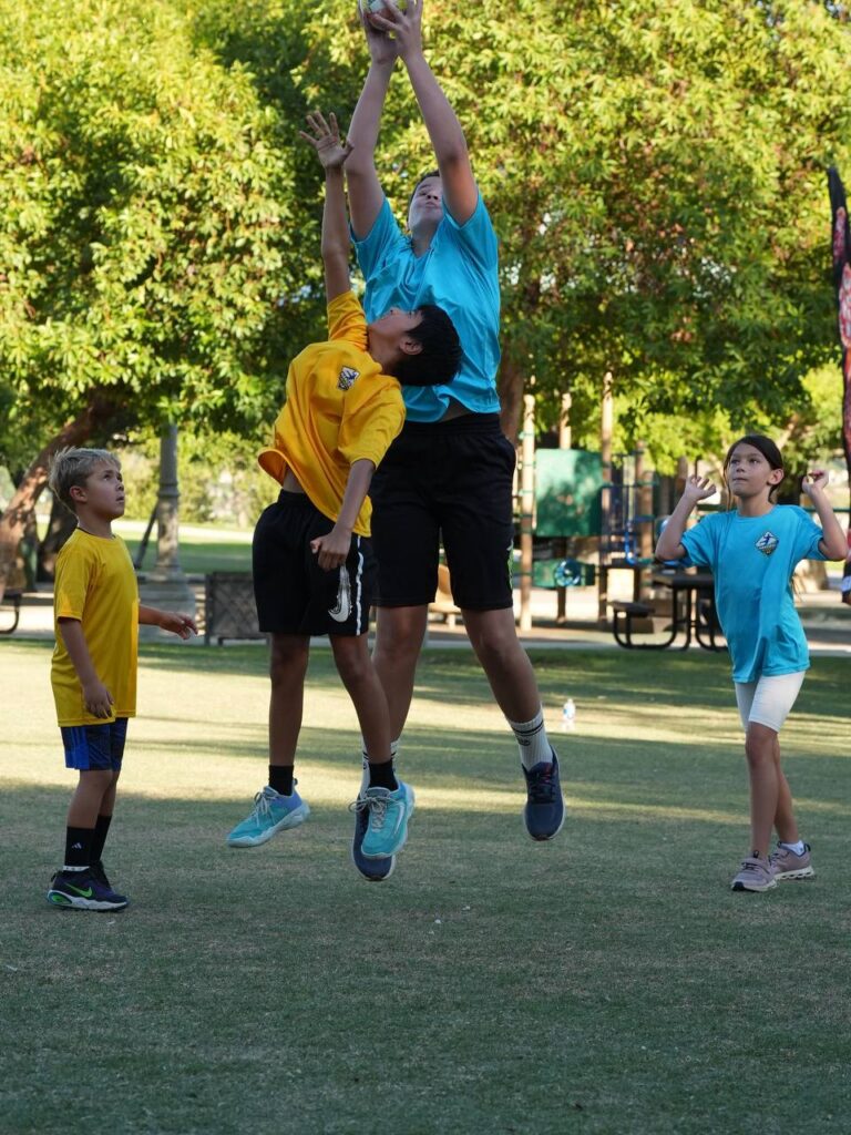 Children jumping for the ball during a handball match